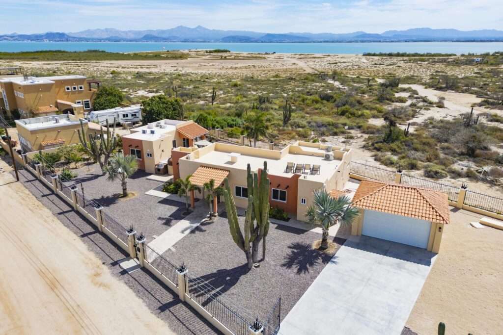 La Paz Lomas Del Centenario, Palo Verde Perched atop the hills of El Centenario, this thoughtfully designed 3-bedroom, 3-bathroom residence offers a rare sense of peace, privacy, and connection to the surrounding desert and sea. Situated on a spacious double lot, the home is fully enclosed, with elegant privacy walls. Backs onto a natural arroyo, creating a tranquil sanctuary without compromising – C. 7, La Paz, BS
