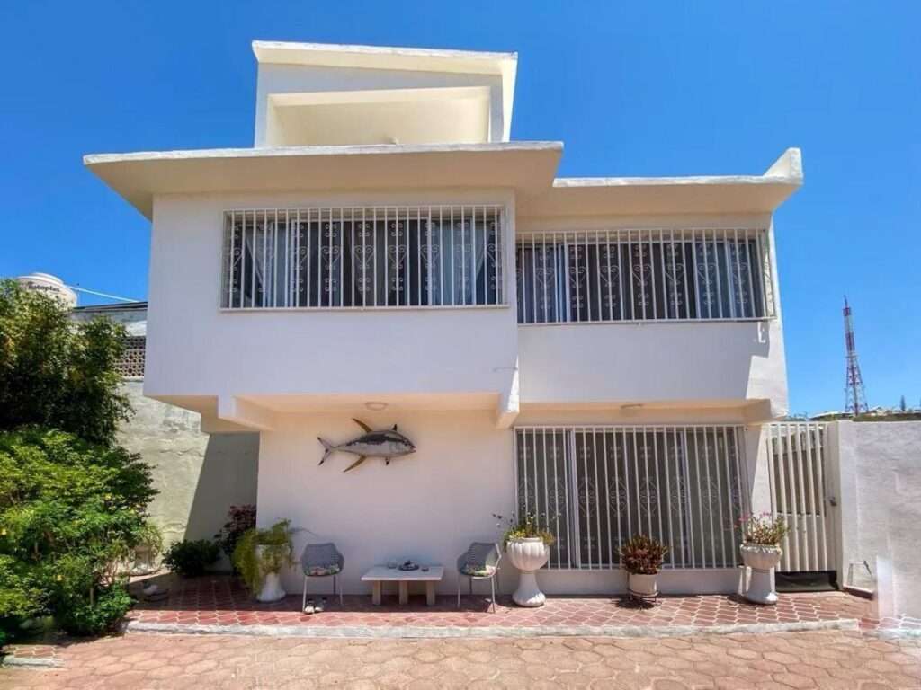 La Paz Centro Exceptional property for sale in the heart of La Paz, Baja California Sur.Located on Lic. Primo Verdad Street in the highly desirable Centro area, this spacious residence blends authentic Baja character with functional modern living. Ideal for families, investors, or developers, the property offers privacy, generous indoor and outdoor spaces, and excellent connectivity to the city's main attractions, restaurants, schools, universities, and shopping areas.Set on a 13,490.52 ft lot with 3,791.58 ft of construction, the home combines the charm of traditional Baja California Sur architecture with tasteful modern upgrades that enhance comfort and functionality.An outstanding added value is its zoning potential, allowing development of up to 7 levels making this an excellent opportunity. for residential living, a boutique project, vacation rental investment, remodeling, or vertical development in one of La Paz's fastest-growing and most connected areas.Property LayoutThe property features 5 bedrooms and 3 full bathrooms distributed between two independent structures:Main Residence* 3 bedrooms* 2 bedrooms with private en-suite bathrooms* Third-level flex room ideal for: * Home office * TV/media room * Gym * Art studio * Game roomIndependent Guest House* 2 additional bedrooms* Shared full bathroom* Perfect for guests, extended family, teenagers, rental income, or private office spaceInterior Features* Spacious and naturally fresh living areas* Large kitchen with excellent functionality* Renovated bathrooms* Polished concrete finishes and authentic architectural details* Layout designed for both entertaining and privacyOutdoor LivingThe exterior spaces are one of the property's greatest highlights, featuring:* Expansive patio and garden areas* Mature fruit trees and lush landscaping* Natural shaded gathering spaces* Outdoor bar and barbecue area* Covered entertainment terrace* Multiple relaxing outdoor corners ideal for family and social gatheringsAdditional Features* Private garage with electric gate* 10,000-liter underground cistern for reliable water storage* Extensive outdoor areas* Multifunctional spaces* Excellent investment and development potential* Prime central location with privacy and tranquilityA unique opportunity to own a character-filled property with exceptional lot size, versatile spaces, and strong development potential in the center of La Paz. – 1030 Calle Lic. Primo Verdad, La Paz, BS