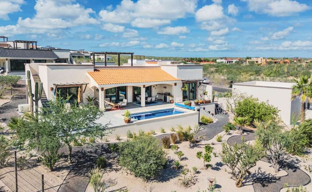 La Paz Villas Del Centenario Step into Casa Los Sueños in Villas del Centenario, where a bright open-concept kitchen, living, and dining space unfolds across 1,941 ft². Dual sliding glass doors draw you outside to a 580 ft² covered patio with tiled roof, overlooking a heated 10' x 22' pool, outdoor kitchen, and expansive 889.5 ft² terrace--perfect for entertaining. Inside, 10' ceilings, oversized tile, custom alder cabinetry, granite countertops, stainless appliances, and a walk-in pantry elevate everyday living. The primary suite offers dual vanities, a marble shower, and walk-in closet, complemented by two guest bedrooms, full bath, half bath, and laundry room. Welcome to Casa Los Sueños, a recently built residence in the master-planned community of Villas del Centenario, where elevated design meets the relaxed rhythm of Baja living. As you enter, you're greeted by an expansive open-concept kitchen, living, and dining area spanning 1,941 ft² of interior space--designed for both everyday comfort and effortless entertaining. Clean lines, 10' ceilings, and oversized ceramic tile create a sense of openness, while custom alder hardwood cabinetry, granite countertops, stainless steel appliances, and a generous built-in pantry bring both function and style to the heart of the home.Natural light pours in through dual sliding glass doors, drawing you seamlessly outdoors to a 580 ft² covered patio with a tiled roof--your shaded retreat for morning coffee or sunset gatherings. Beyond, a sparkling heated 10' x 22' pool anchors the outdoor living space, complemented by a fully equipped outdoor kitchen and an additional 889.5 ft² of uncovered patio, offering ample room for lounging, entertaining, or simply enjoying the Baja climate – 7026 Calle aceso s/n, La Paz, BS