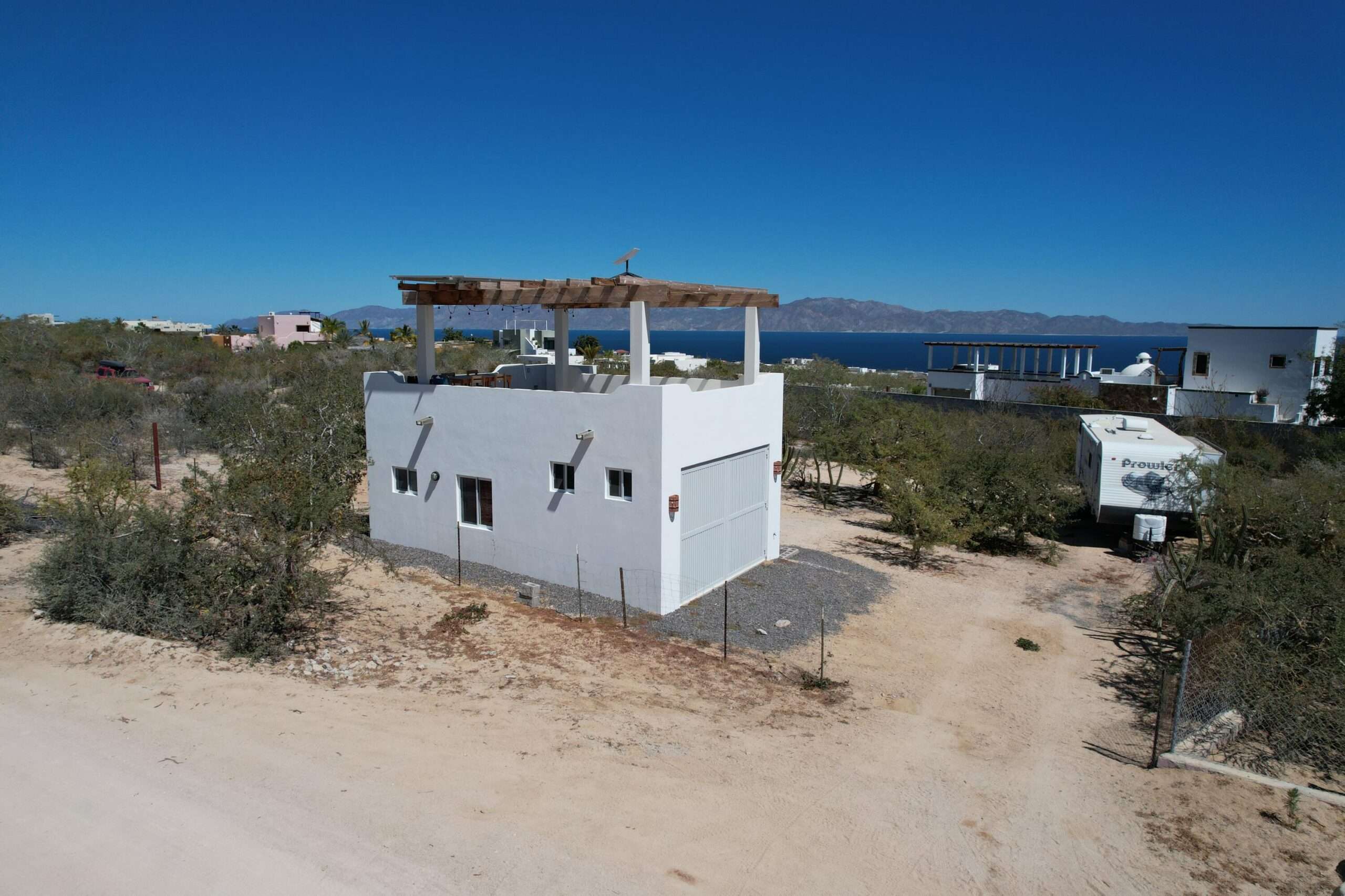 La Paz El Sargento Discover an incredible opportunity to own a beautiful unit in El Sargento, where comfort, sustainability, and Baja charm come together. This unique property features a solid structure with a thoughtfully designed interior, including a full bathroom and functional cooking area--perfect for immediate use or future expansion. Enjoy a spacious rooftop terrace with a pergola, ideal for relaxing. Designed for off-grid living, it includes six solar panels, a 15,000-liter cistern, and a septic system--offering a fully self-sustaining setup. As a bonus, a 2013 Prowler camper is included, providing extra space for guests or flexible living. for sale