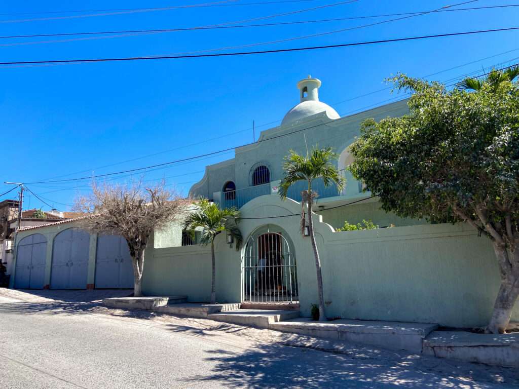 La Paz Alttus Homes Casa Palmira | For Sale in La Paz, Baja California SurCasa Palmira is a spacious and functional property located just one block from the Malecón, allowing you to enjoy the beach, restaurants, and local lifestyle within walking distance.The home features 2 bedrooms with closets and 3 full bathrooms, offering a practical and well-designed layout. The interior spaces are open and comfortable, with a living and dining area connected to a fully equipped kitchen, ideal for everyday living.From the living area, you have access to a patio with greenery, bringing in natural light and ventilation, creating a fresh and inviting atmosphere. Upstairs, the property offers two terraces, perfect for relaxing, enjoying outdoor living, or adapting into additional social spaces. Additional features include a covered garage for 2 cars, a basement ideal for storage or multiple uses, and a cistern for reliable water supply. The home is partially furnished, making it ready to move in or rent out.Thanks to its layout, outdoor areas, and location, Casa Palmira is an excellent option for both living and rental investment. – Palmira, La Paz, BS
