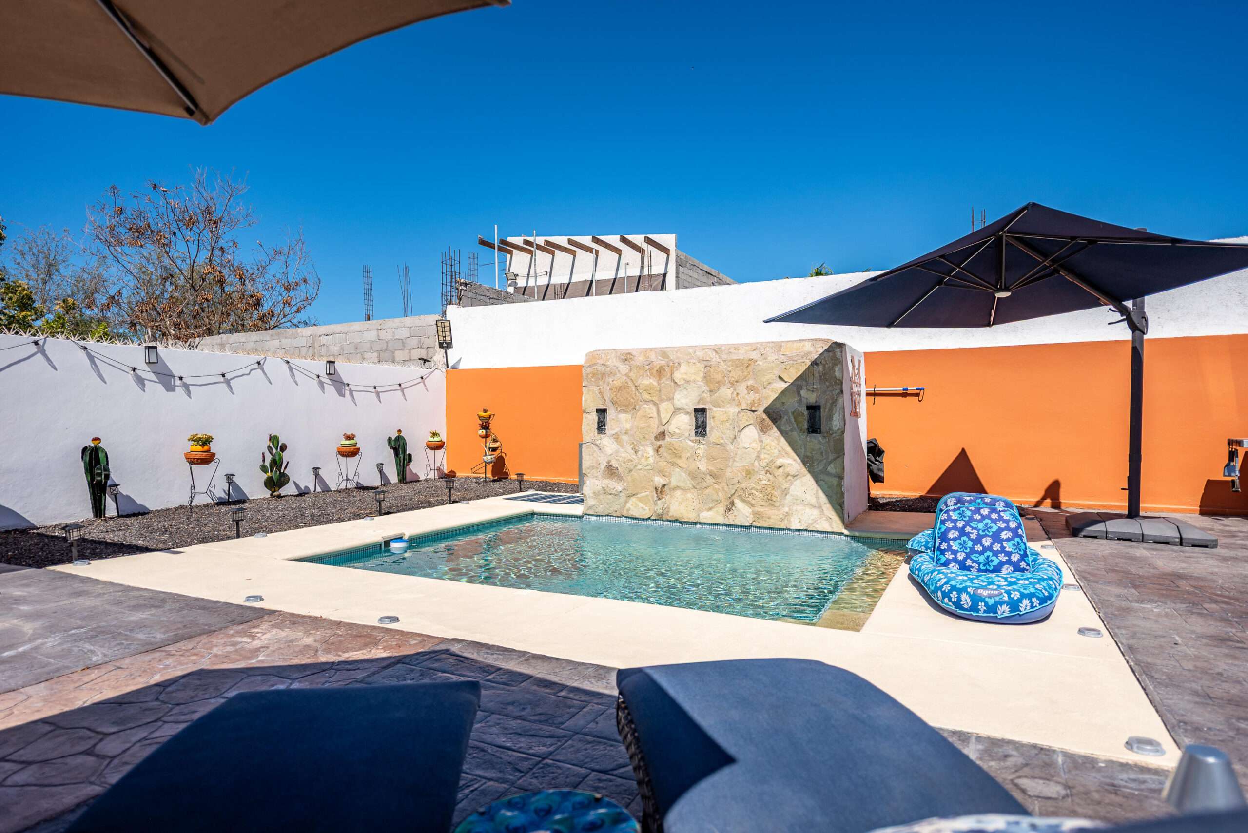 La Paz Chametla Beautifully designed single-story turnkey home nestled in the desirable community of Chametla. Thoughtfully crafted with high-quality finishes and professionally decorated throughout.Offering 3 bedrooms, 2 full bathrooms, and 1 half bath, this open-concept home is filled with natural light from large living room and kitchen windows. The modern kitchen features a granite island, custom cabinetry with elegant glass-front doors, and custom blinds throughout.Step outside to your private backyard oasis with a heated in-ground pool, cascading water feature, shaded lounge area, BBQ space, and low-maintenance landscaping. The property is fully walled and gated for privacy, featuring an electric gate, covered parking for two vehicles, and a whole-home water filtration system. – 600 Calle Zacatecas, La Paz, BS